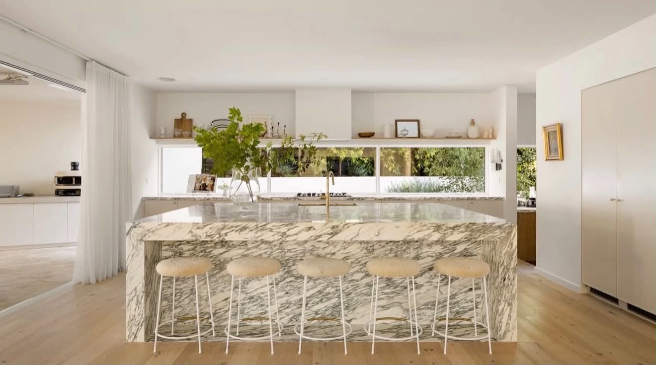 Bespoke kitchen with a marble island and custom cabinetry by Masterpiece Cabinetry